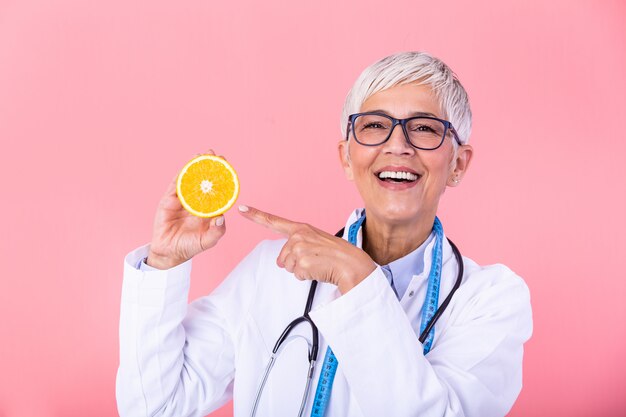 Nutritionist with healthy fruit, juice and measuring tape.