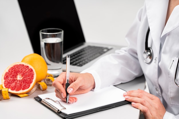 Nutritionist writing on a clipboard