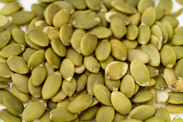 Nutritious nut pumpkin seeds on white background