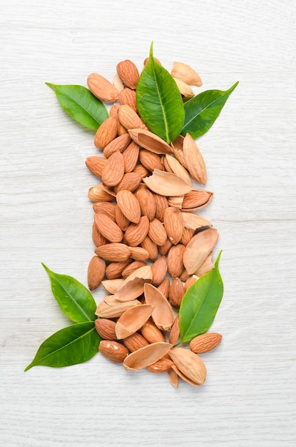 Nuts Almonds on a white wooden table Top view Free space for your text