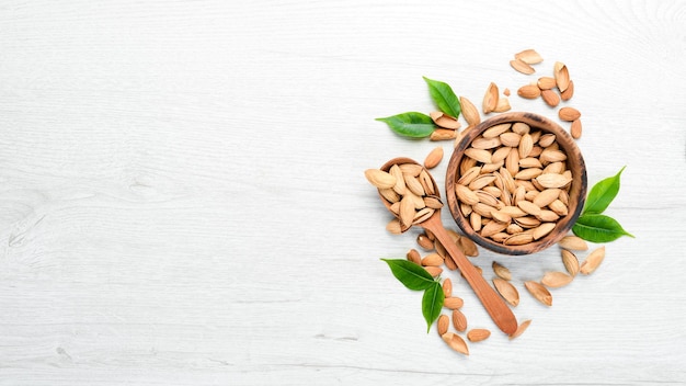 Nuts Almonds on a white wooden table Top view Free space for your text