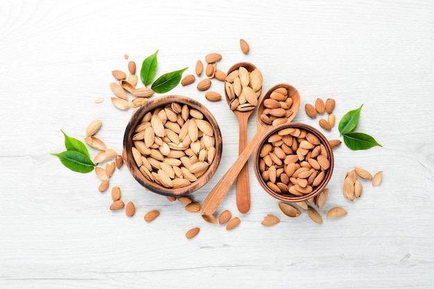 Nuts Almonds on a white wooden table Top view Free space for your text