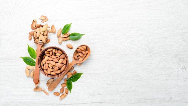 Nuts Almonds on a white wooden table Top view Free space for your text