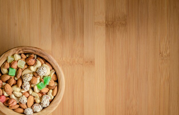 Nuts in assortment on a wooden background with a place to copy.