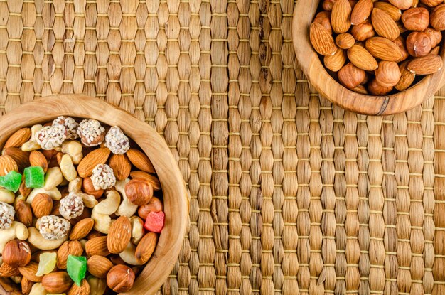 Nuts in assortment on a wooden plate with a place to copy.