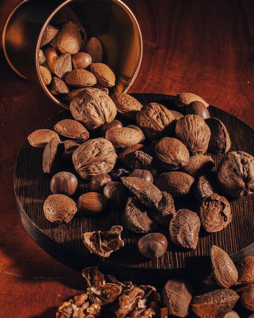 Nuts in a metal decorative bucket on wooden table