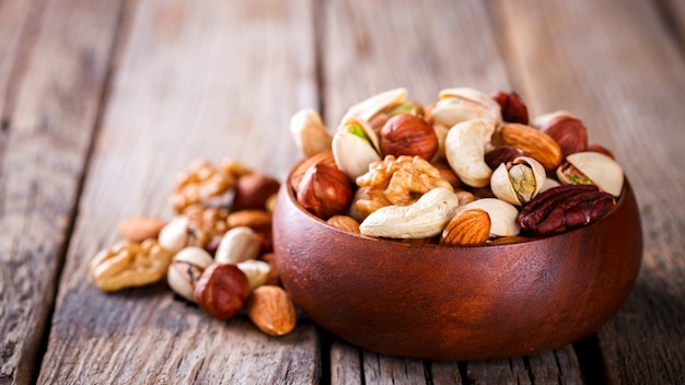 Nuts Mixed in a wooden plate.