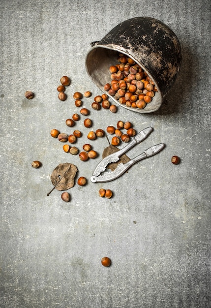 Nuts in the old pot. On the stone table.