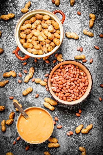 Nuts and peanut butter in a bowl. On rustic background.