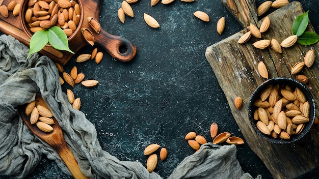 Nuts protein Almonds on black stone background Top view Free space for your text