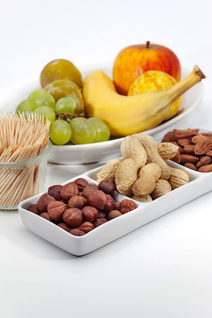 Nuts and seasonal fruits on a white background