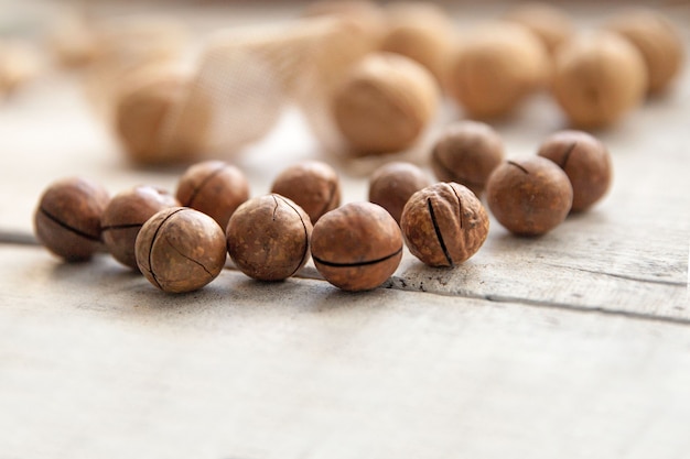 Nuts in a shell on a white wooden background, with a blur