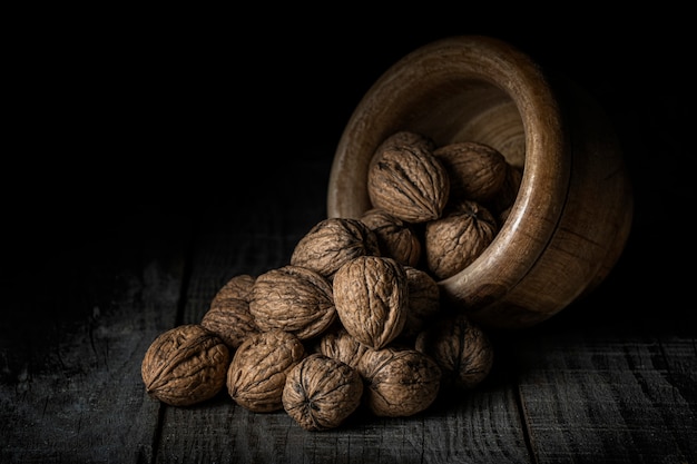 Nuts spilled from a wooden bowl