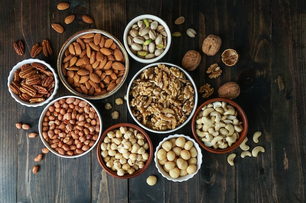 Photo nuts variety in the bowls cashew hazelnut macadamia pistachio almond walnut peanut pecan