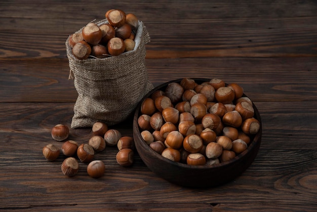 Nuts in wood bowl wooden backround