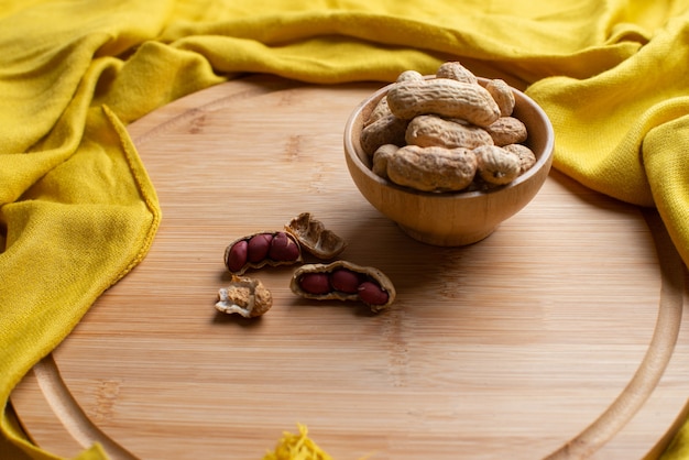 Nuts on the wooden bowl with yellow scarf