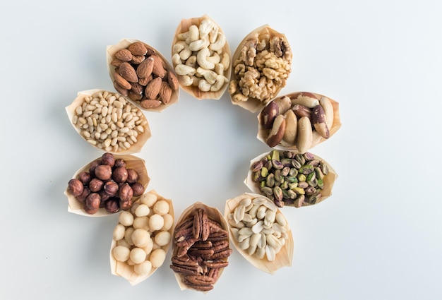 nuts in wooden bowls are arranged in the shape of a flower and petals