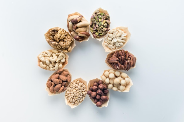 nuts in wooden bowls are arranged in the shape of a flower and petals