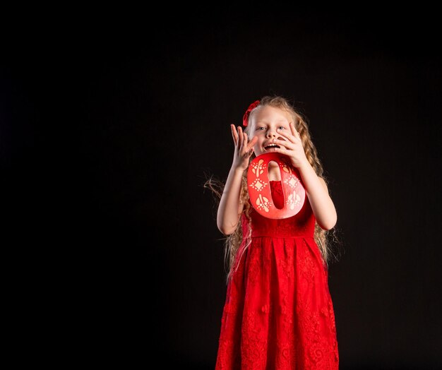 O holds Baby holds in his hand the letter LOVE the design of Valentine's Day on the floor hearts