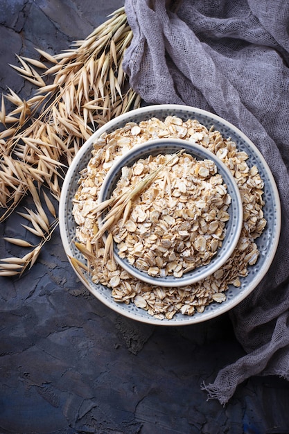 Oat flakes in bowl and spikelets