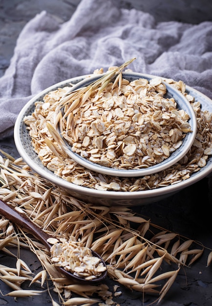 Oat flakes in bowl and spikelets