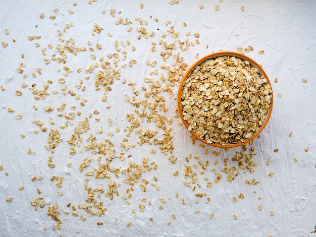 Oat flakes in glass jar on table. Top view. Uncooked oatmeal