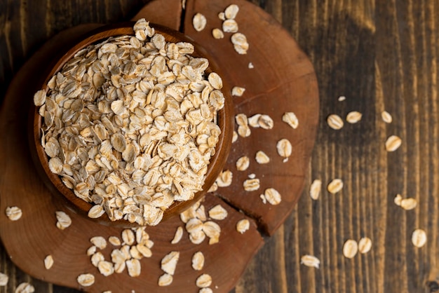 Oat flakes poured into a wooden bowl
