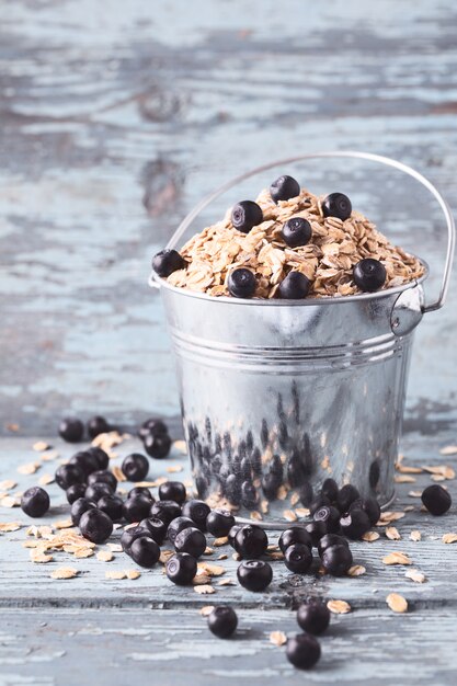 Oat flakes with blueberries in a bucket