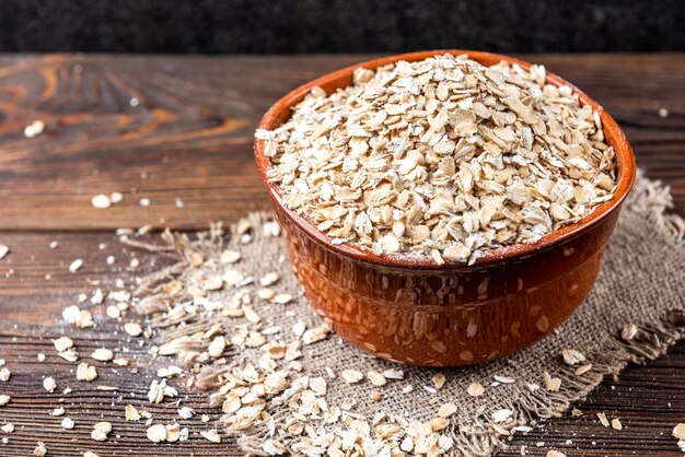 Oat flakes on a wooden bowl