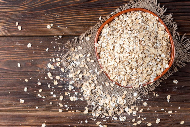 Oat flakes on a wooden bowl