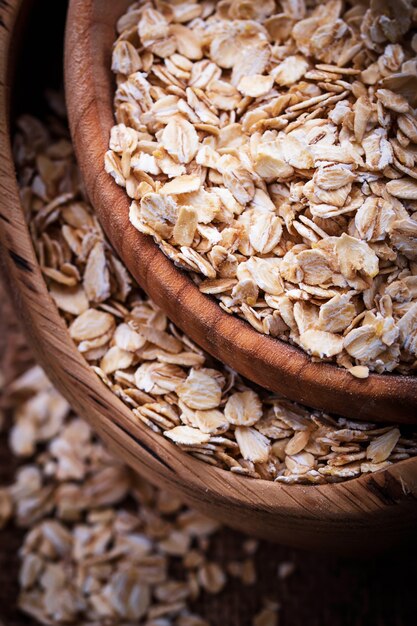 Oat flakes in wooden bowl