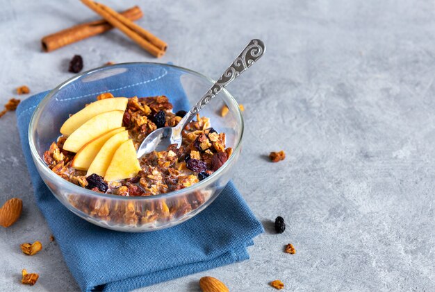 Oat granola with apples in a transparent bowl