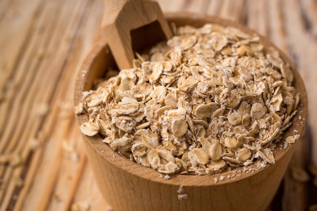 Oat groats in bowl on a wooden background Healthy dietary cereals concept