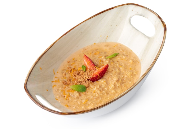 Oat meal porridge with strawberry in bowl isolated on white