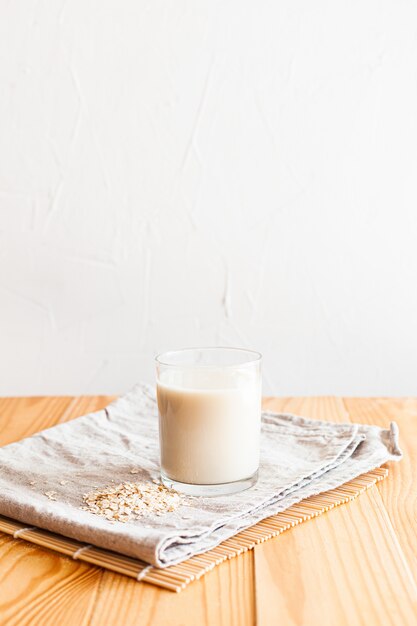 Oat milk in a glass on a table