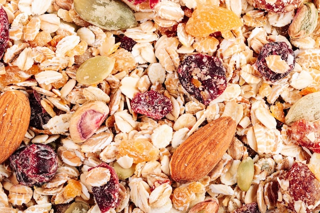 Oat muesli with nuts dried berries and seeds closeup top view