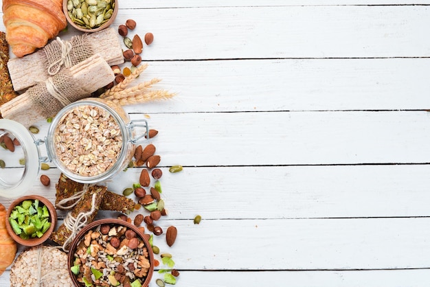 Oatmeal bars muesli flax healthy snacks On a white wooden background Top view Free space for your text