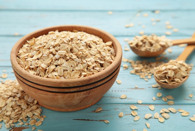 Oatmeal in bowl on blue background Healthy eating concept