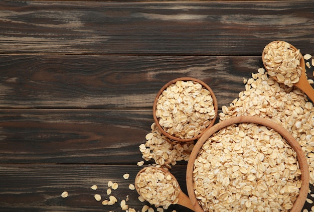 Oatmeal in bowl on brown background Healthy eating concept Space for text