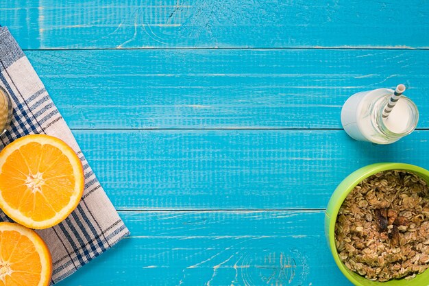 Oatmeal breakfast with orange and milk. Healthy breakfast. View from above. Copy space