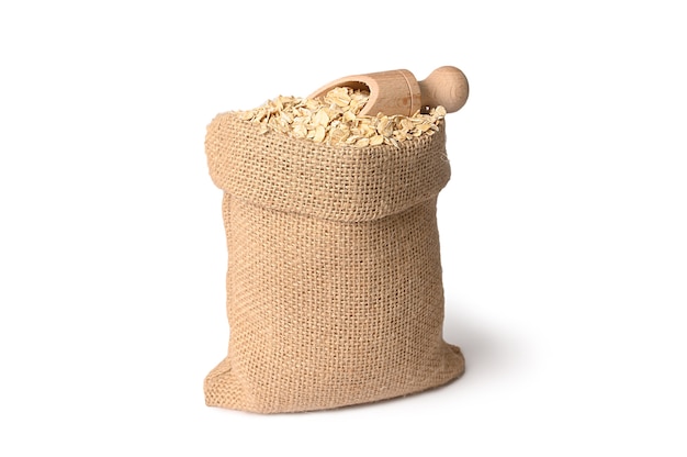 Oatmeal in a burlap sack with a small scoop. Diet food.