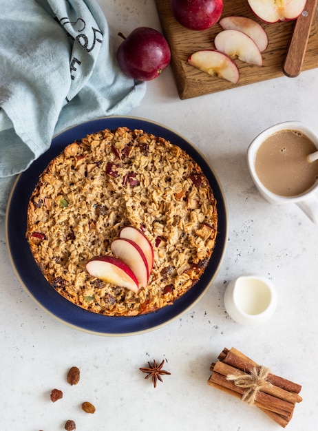 Oatmeal cake or baked oatmeal with apples and raisin. Dietary autumn breakfast. 