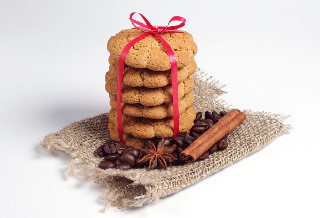 Oatmeal cookies, cinnamon, anise and coffee beans on a white background