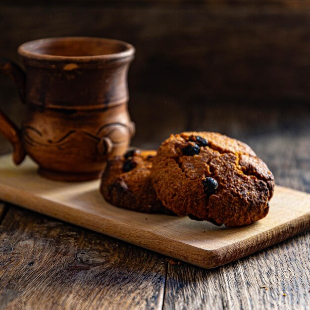 Oatmeal cookies and a cup of coffee on a wooden table