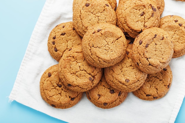 Oatmeal cookies on a napkin on a blue background. Top view