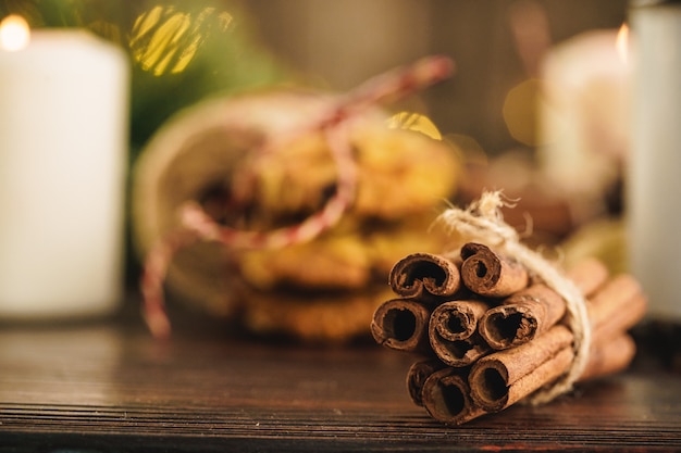 Oatmeal cookies on a old wooden with cinnamon sticks and decorations