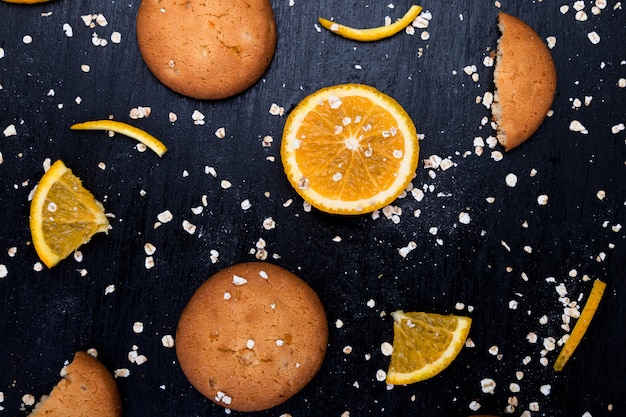 Oatmeal cookies and orange citrus fruit background