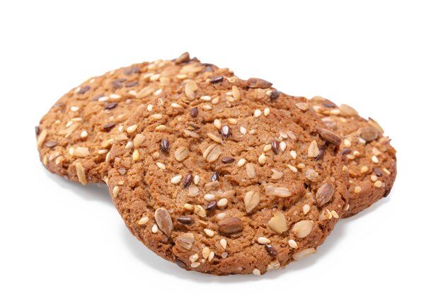 oatmeal cookies sprinkled with cereal grains on white background with soft shadow