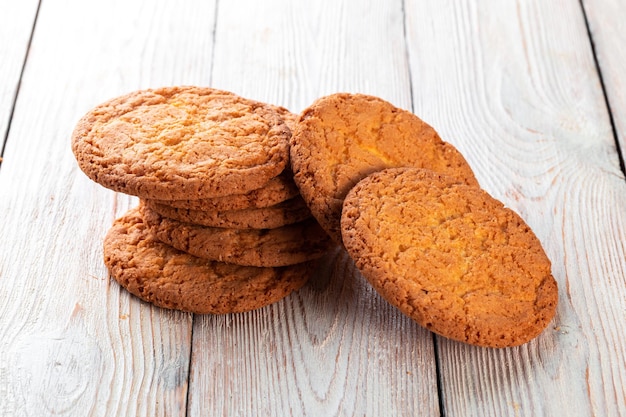 Oatmeal cookies on the white wooden background