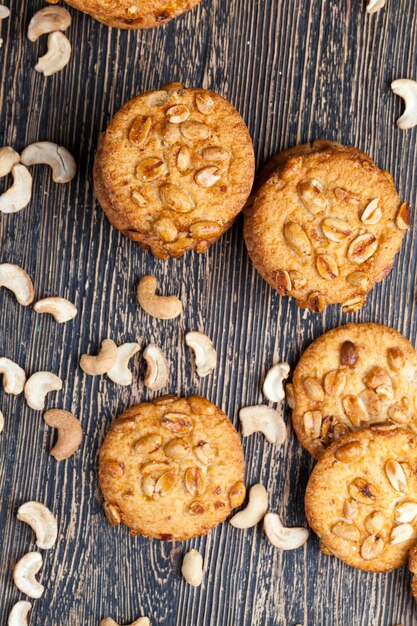 Photo oatmeal cookies with the addition of dried fruits and various types of nuts including peanuts wheatoatmeal cookies with peanuts